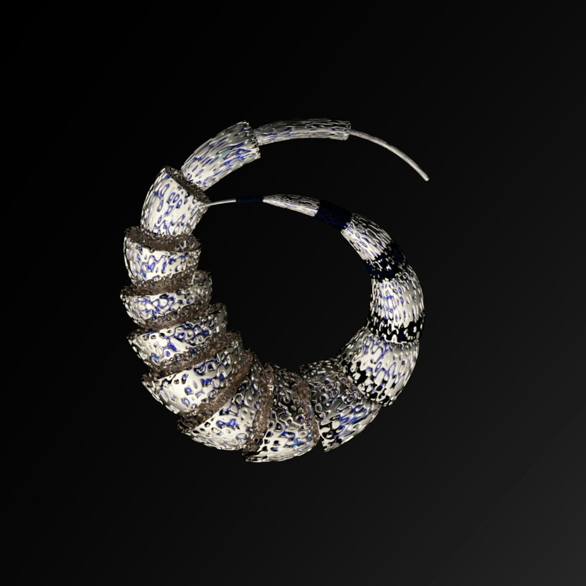 a close up of a metal object on a black background